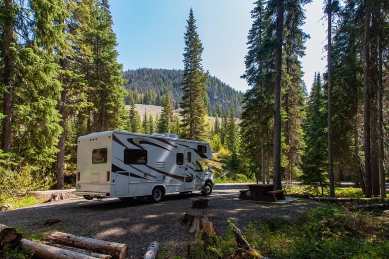 beautiful campsite mountains with rv wooden bench scaled
