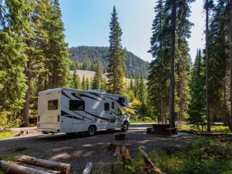 beautiful campsite mountains with rv wooden bench scaled