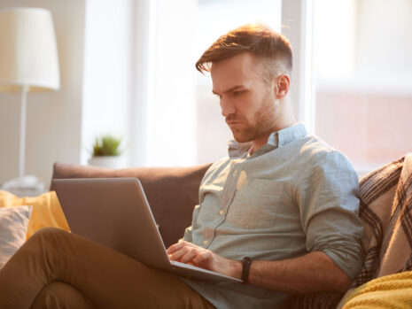Handsome Man Using Laptop at Home handsome man using laptop home scaled