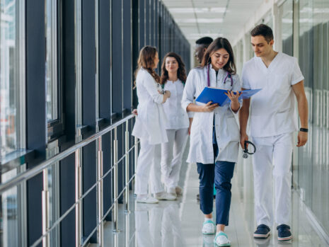 team young specialist doctors standing corridor hospital scaled