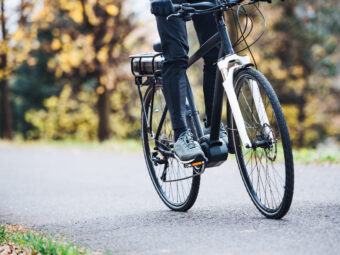 unrecognizable man electrobike cycling outdoors road park scaled