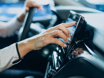 woman touching screen her car scaled