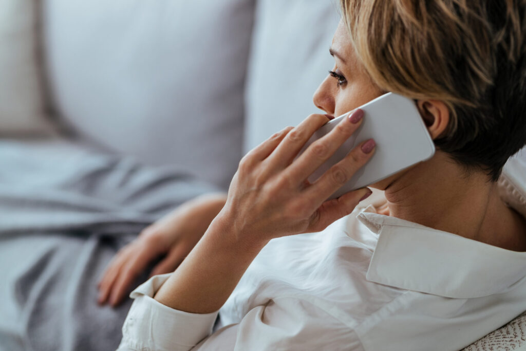 distraught woman resting sofa communicating mobile phone scaled