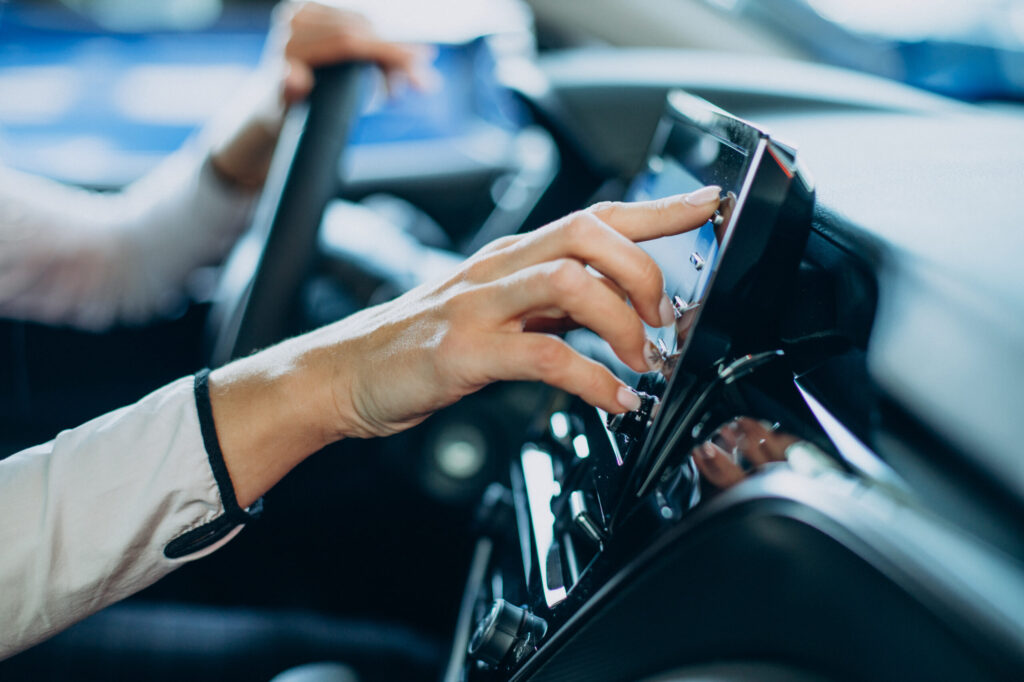 woman touching screen her car scaled